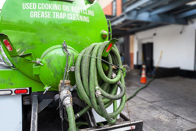 a professional service truck pumping a grease trap in Dunkirk, IN